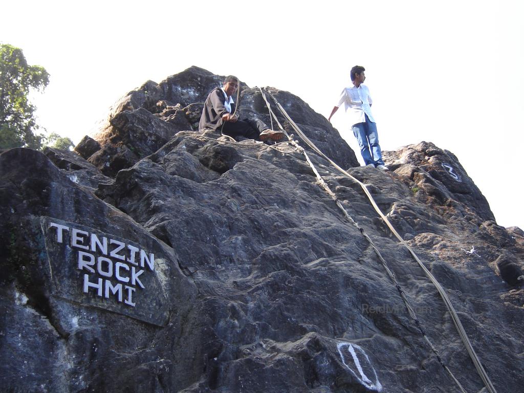 Tenzin Rock, with ropes and Rojesh standing at the top
