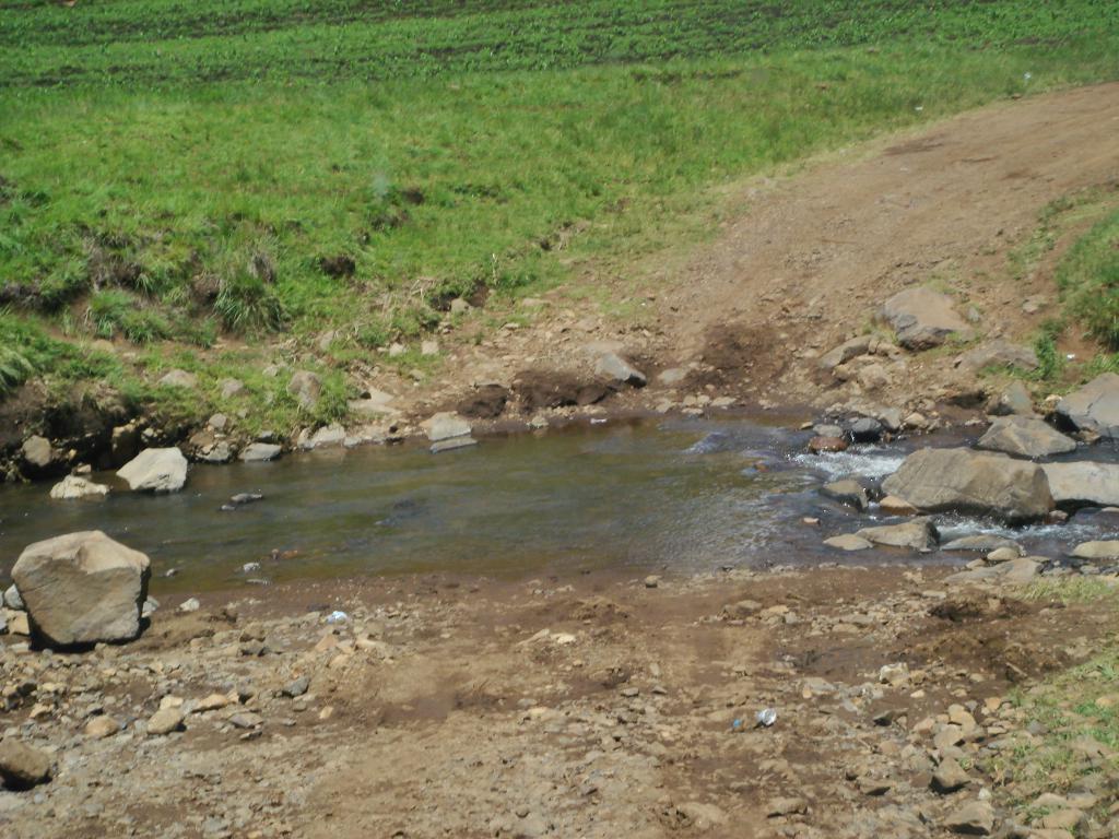 A creek going with the road going right through it