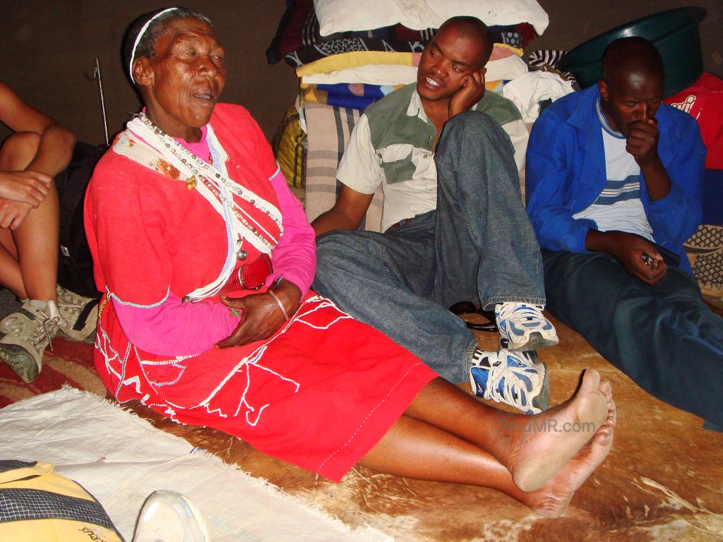 Lesotho medicine woman, an elderly woman with people around her