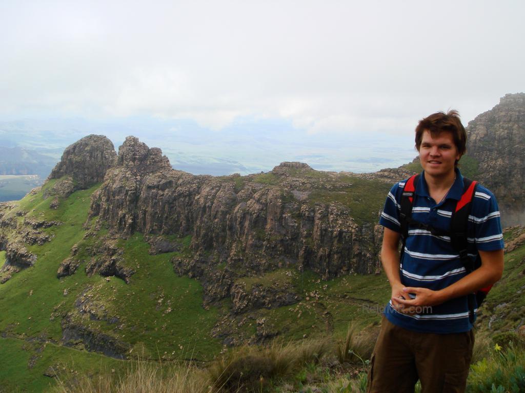 Me hiking, with beautiful mountain scenery behind