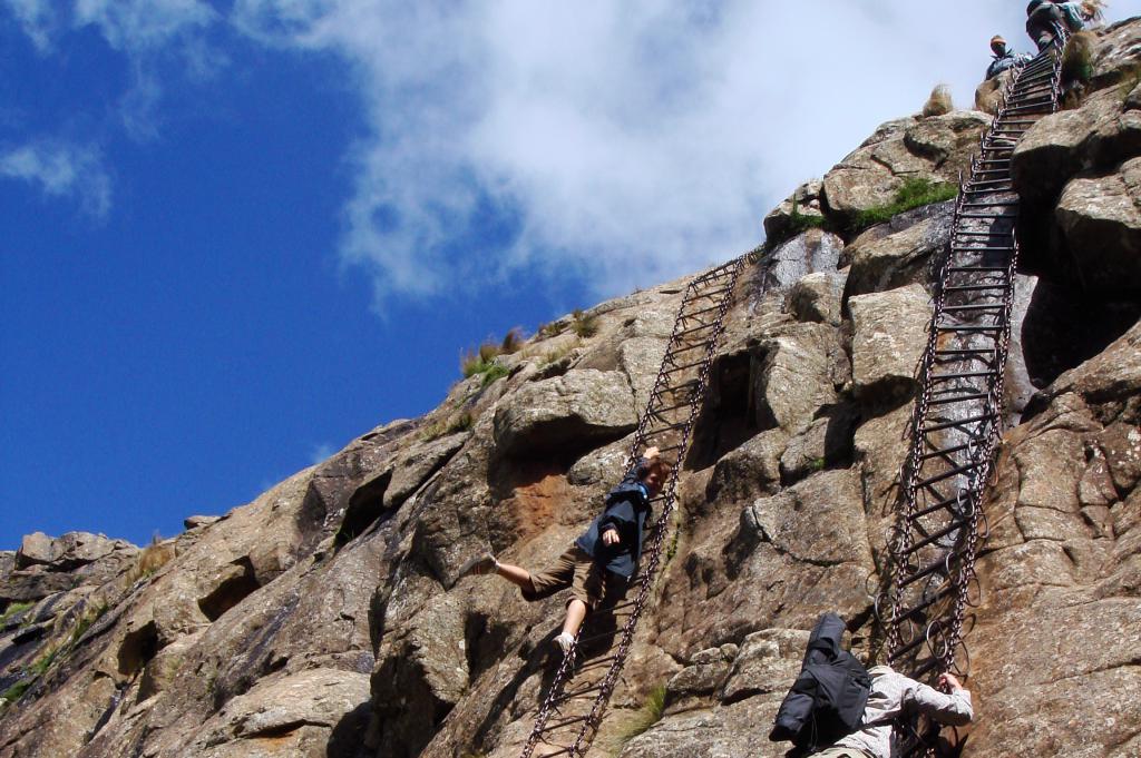 Me hanging from a chain ladder on the edge of a cliff