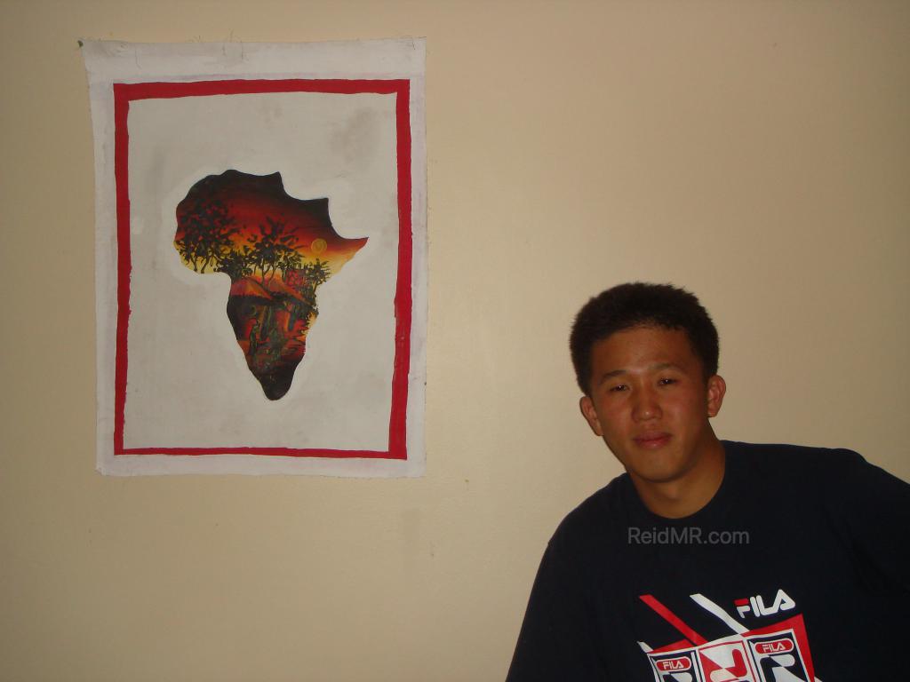 Matsu posing with my other painting, a map of Africa.