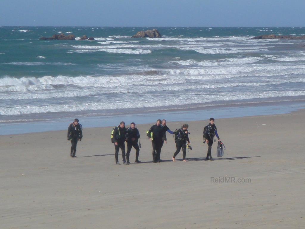 A group of surfers in Port Elizabeth on the beach.