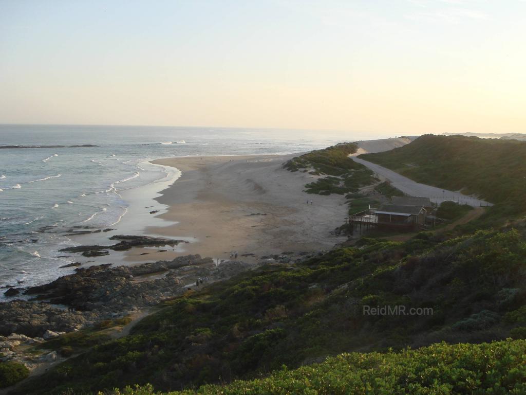 Sardinia Bay, a great overview of the bay from a high vantage point near sunset, with the greenery and ocean in view.