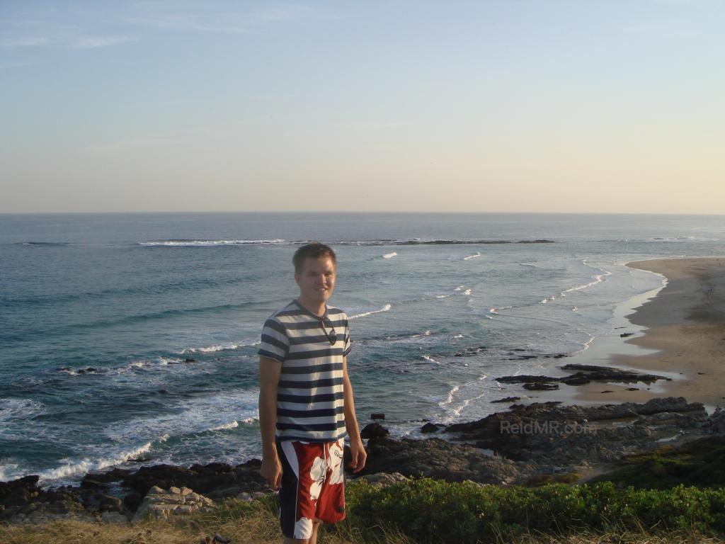 Me at Sardinia Bay, a great overview of the bay from a high vantage point near sunset, with the greenery and ocean in view.