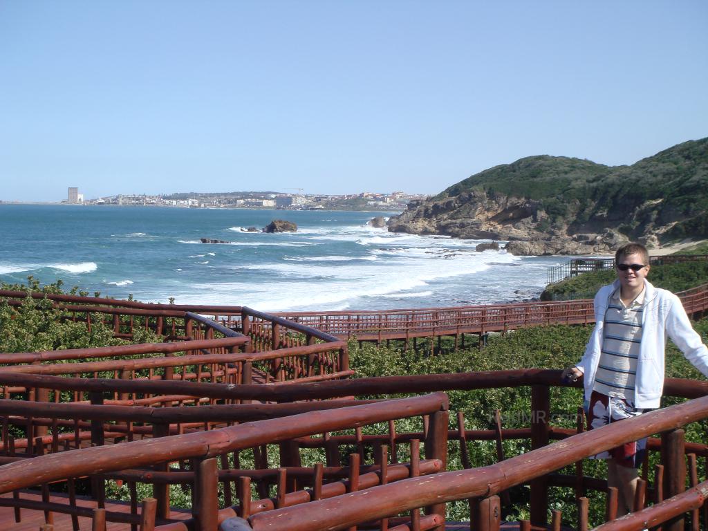 At the end of the dock in East London after a hike. Lots of railing, me, and the ocean.