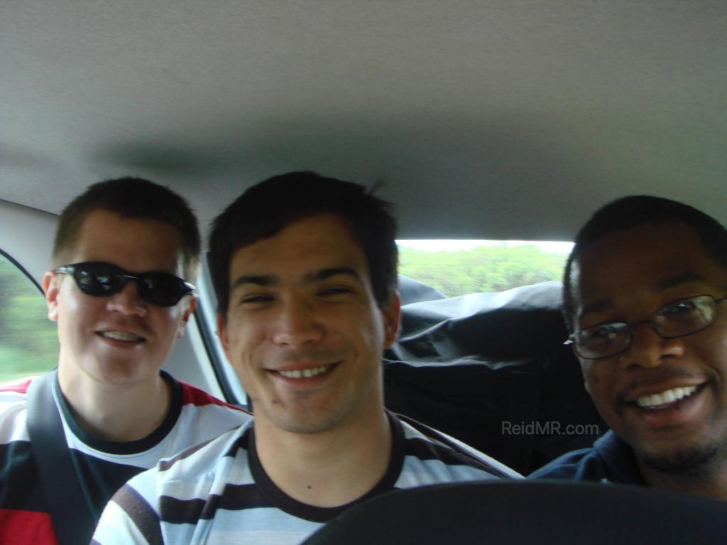 Three happy guys on the way home in the back of the car.