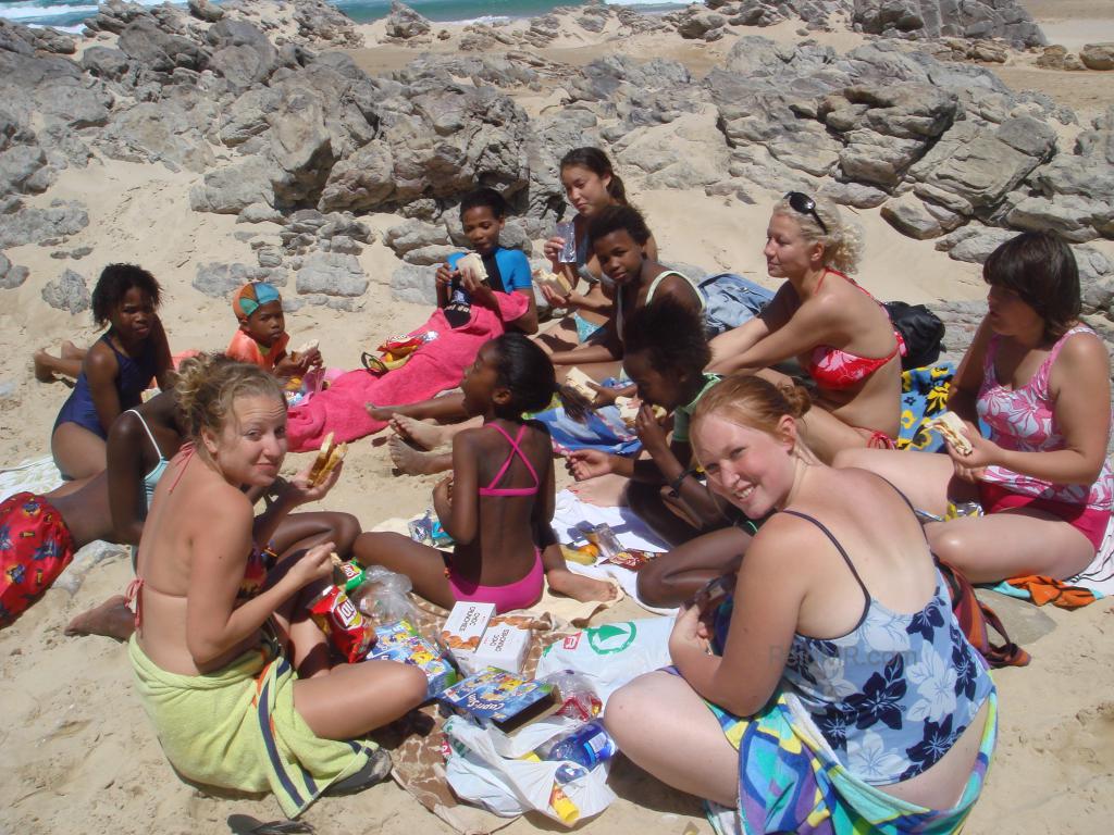 At Sardinia Bay with our students, sitting on the sand.