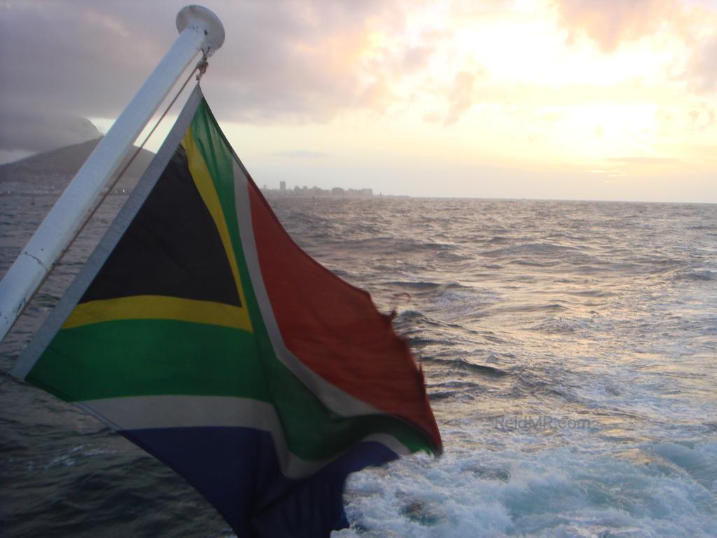 Sea Princess's South African flag with the ocean and sun in the background.