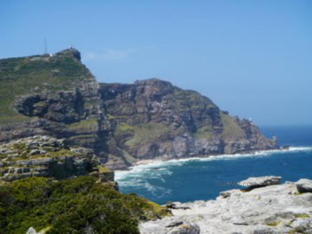 Cape Point from Cape of Good Hope, the mountainous rocky terrain jutting into the ocean.