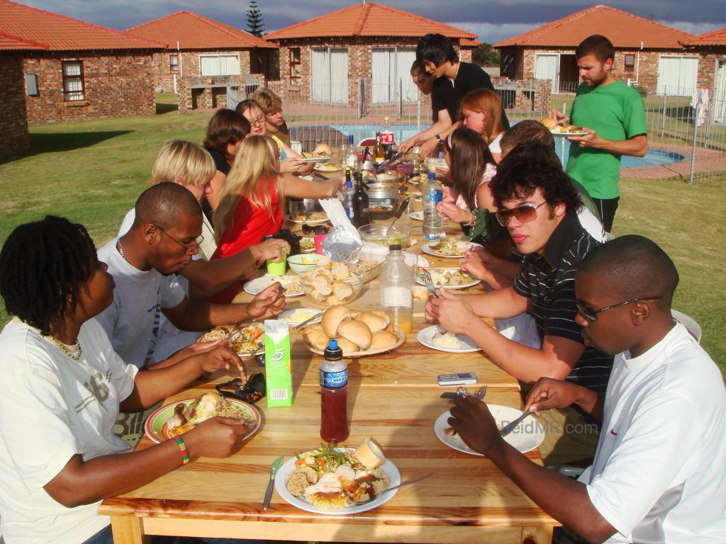 Thanksgiving Dinner, table of food, filled with people, about a dozen people