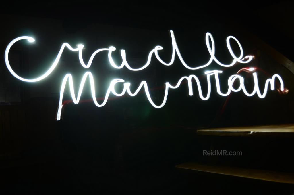 "Cradle Mountain" written with a light looking like a white neon sign.