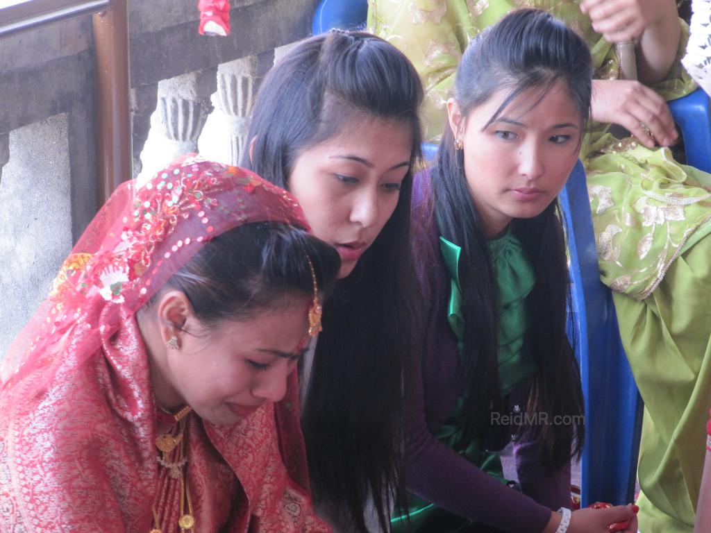 Rojina, Urika and another friend at her wedding. She is crying. 