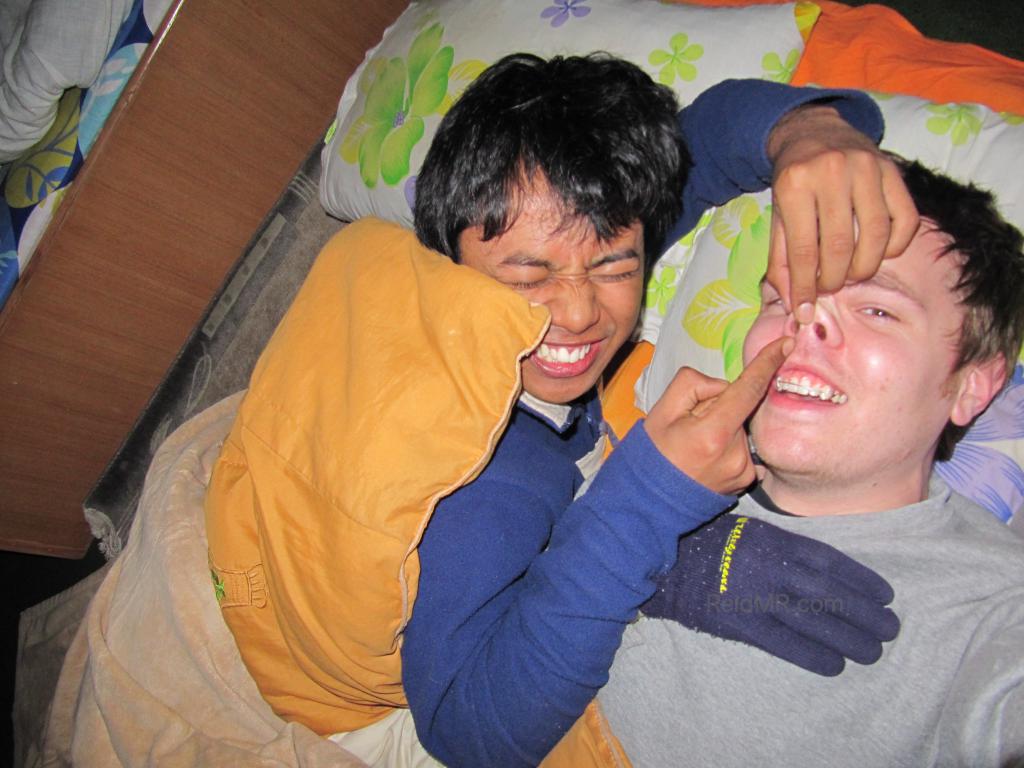 Samridh and I at his cousins house in bed, he is playing with my nose