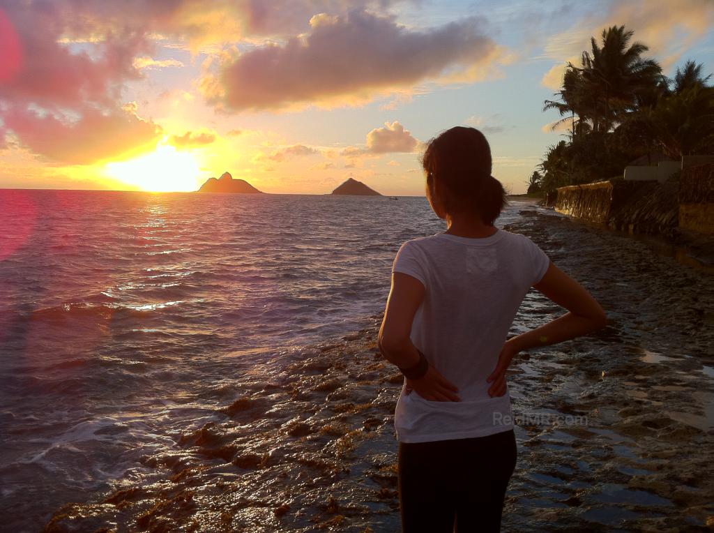 Lexa with the ocean and sunrise in the background on Kailua Beach