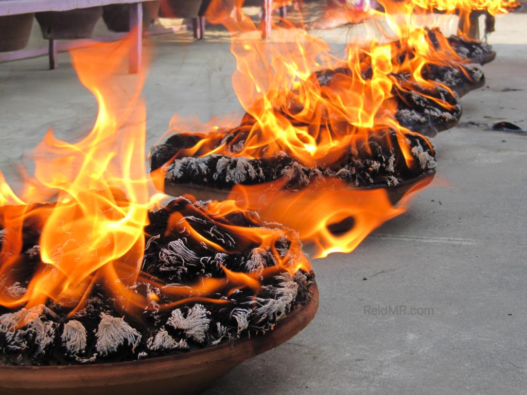 Clay pots with thousands of wicks burning a nice orange color