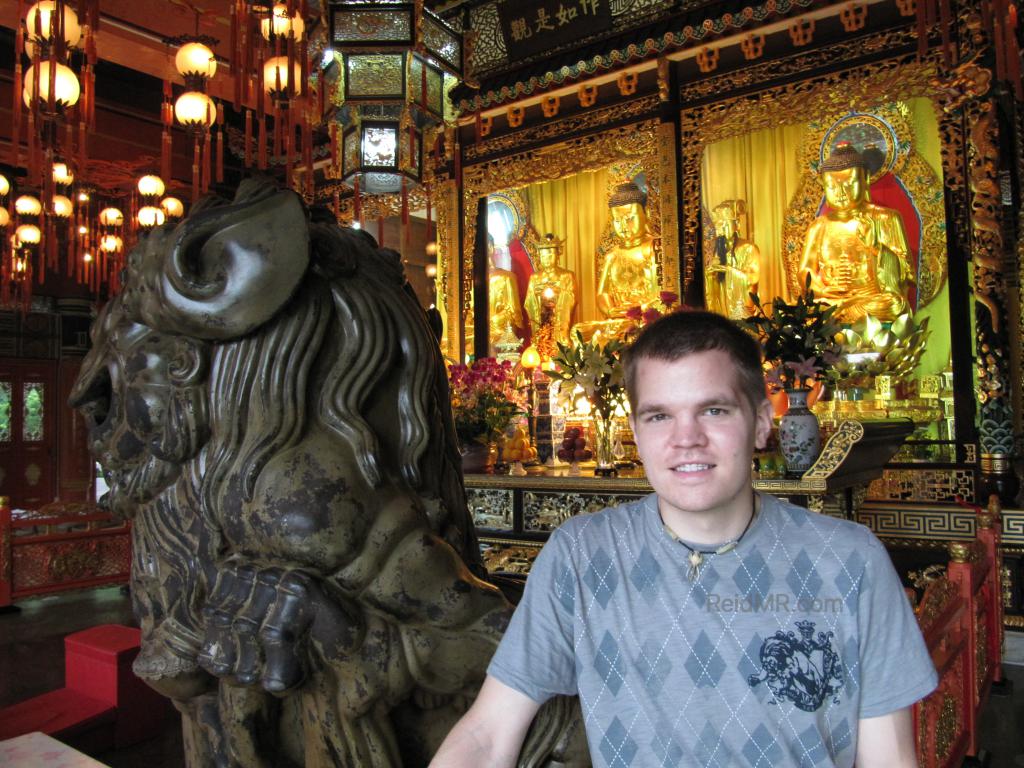 Inside of a tempe with an unusual statue behind me. 