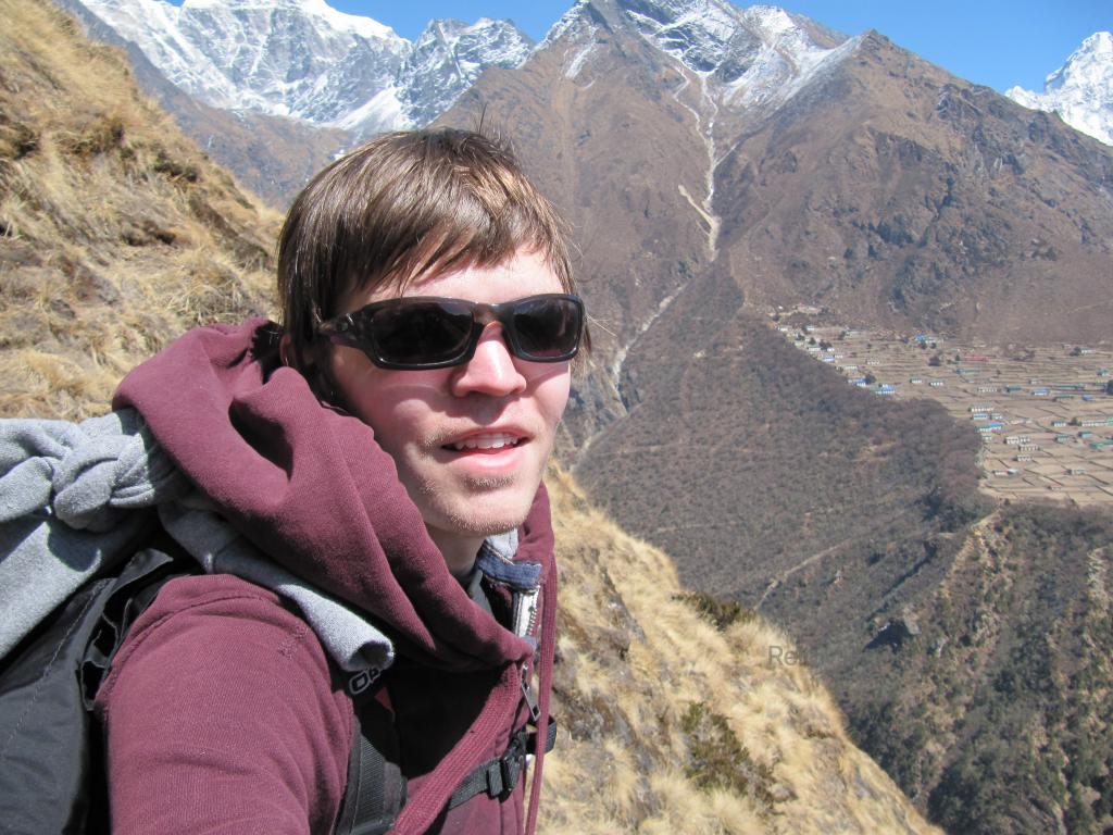 Me with mountain slope in background, very steep slope. I am on the slope. 