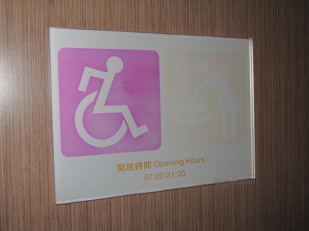 Interesting handicapped sign for the restroom, looks like the person is racing in the Olympics or something 