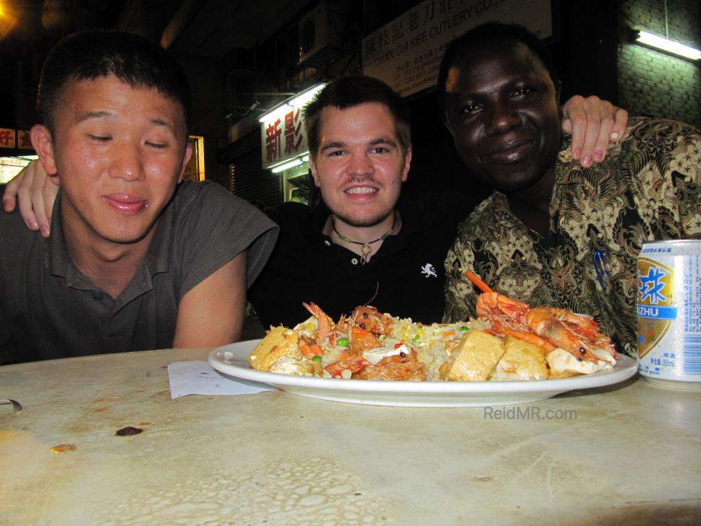 Matsu, myself and a stranger eating rice outside on the Hong Kong street. 