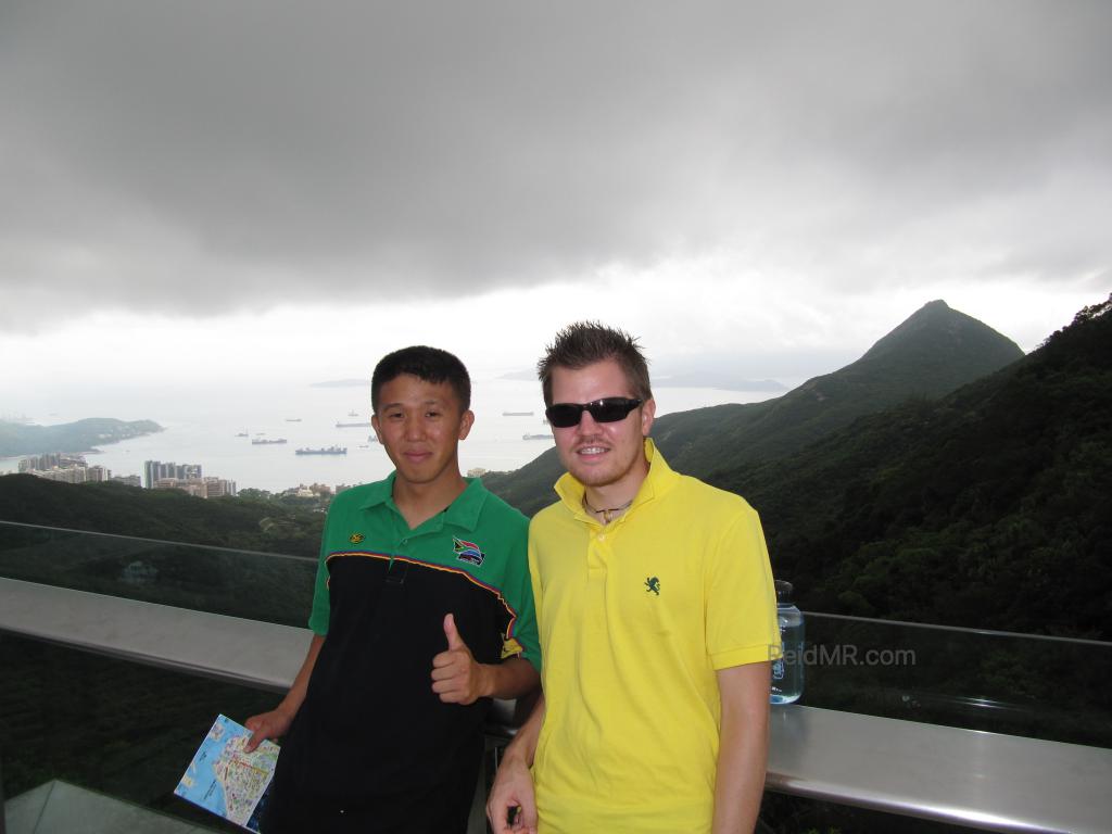 Matsu and I at Victoria Peak, with mountains and clouds in background. 