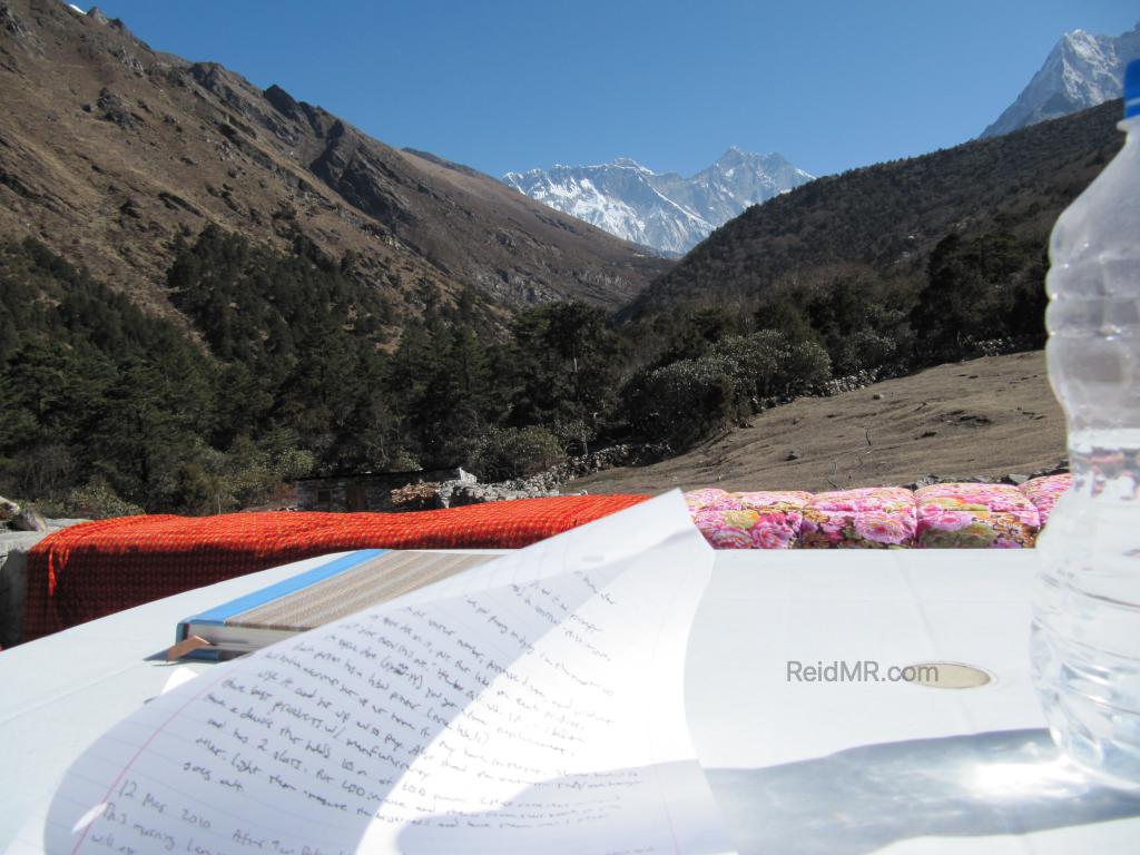 Writing in journal with Everest in background