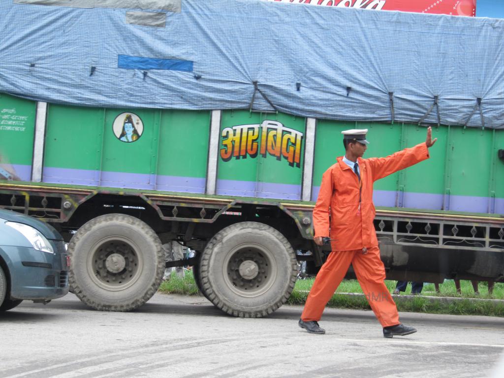 Traffic officer directing traffic in the middle of the road