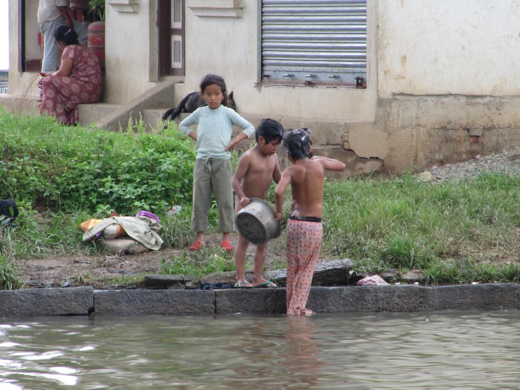 Kids bathing in the pond