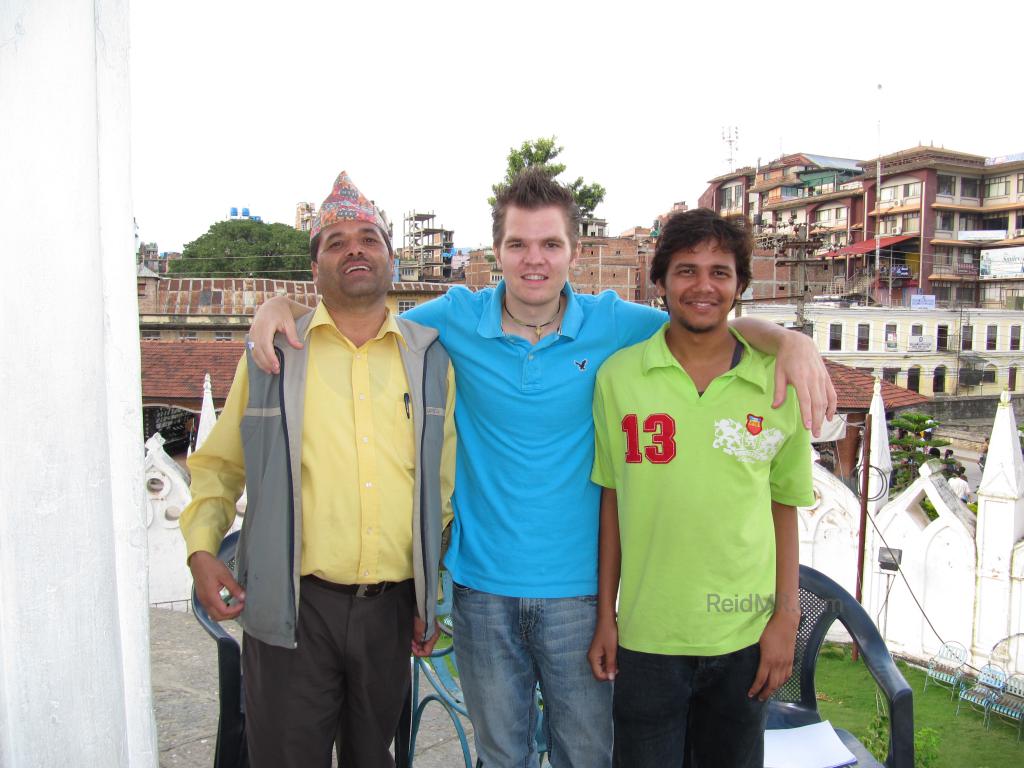 Uncle, me, Santosh posing for a photo, Kathmandu in background