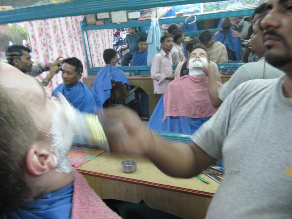 Getting a shave in Dharan, with the foam on my face