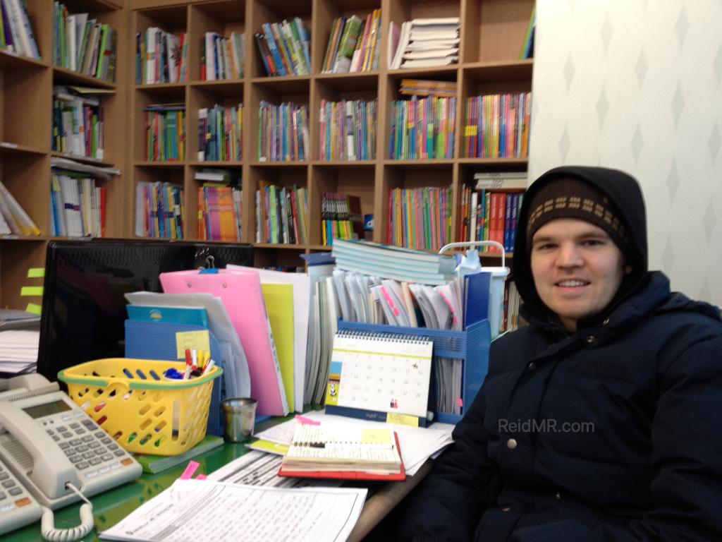 Me in the classroom preparing for class in full winter hat, gloves and jacket