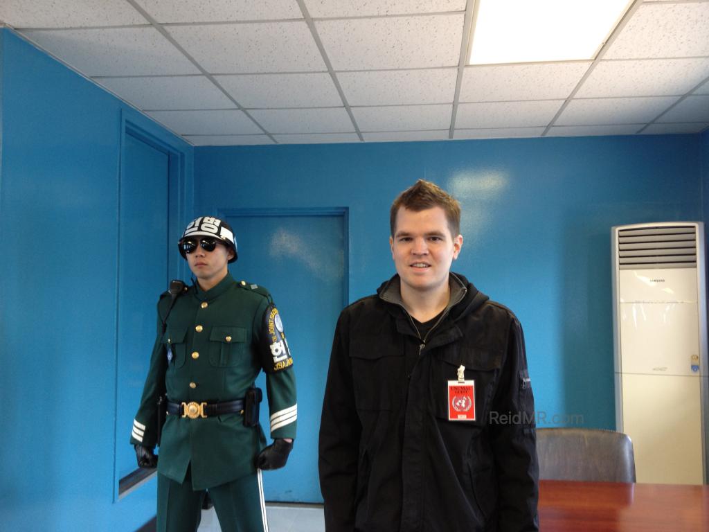 In a Blue Conference Room standing by a South Korean guard, technically in North Korea