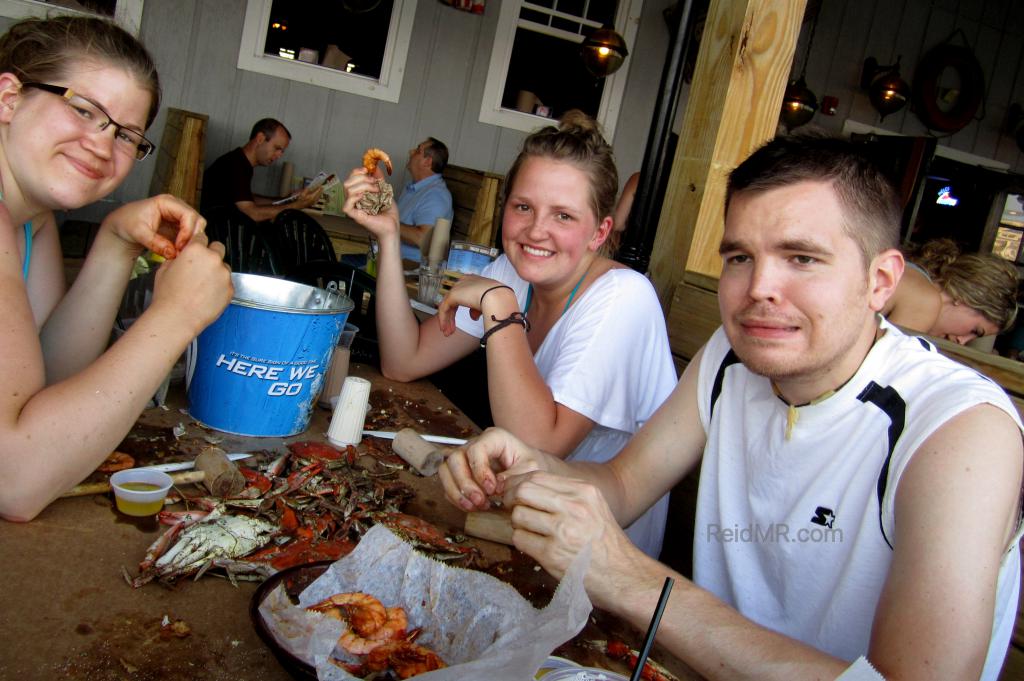 Brittany, Kate, and I are eating crabs. I am making a strange face. (C) 2011 - Lacey. Used with permission. 