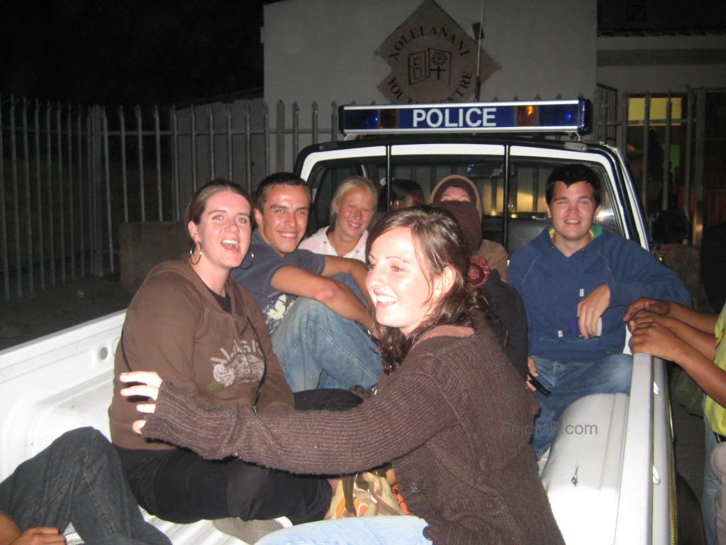 A group of us sitting in the back of the police pickup.