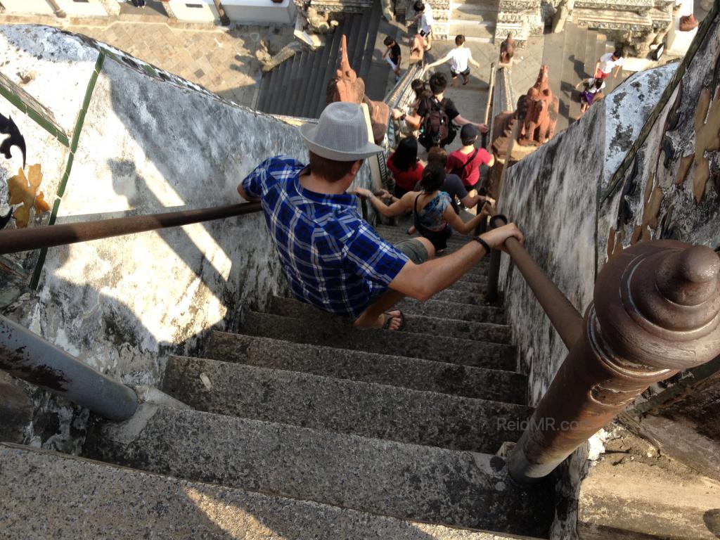 Wat Arun very steep steps with someone going down them 