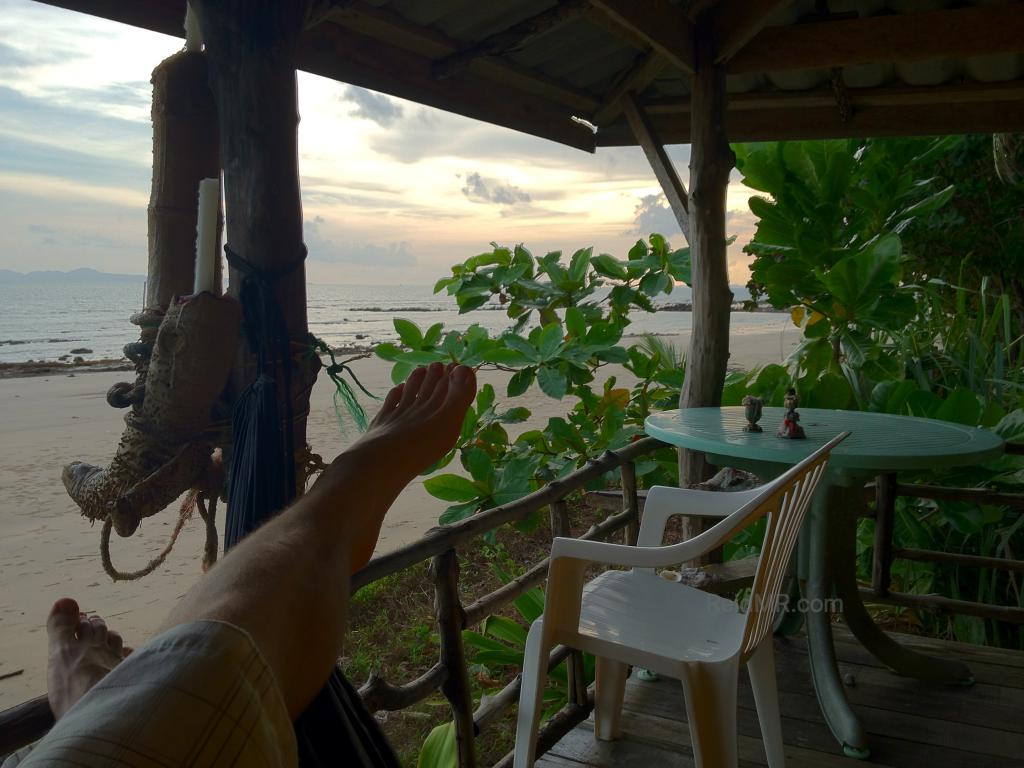 My feet with the sunset starting and the beach, hammock and deck in sight. 