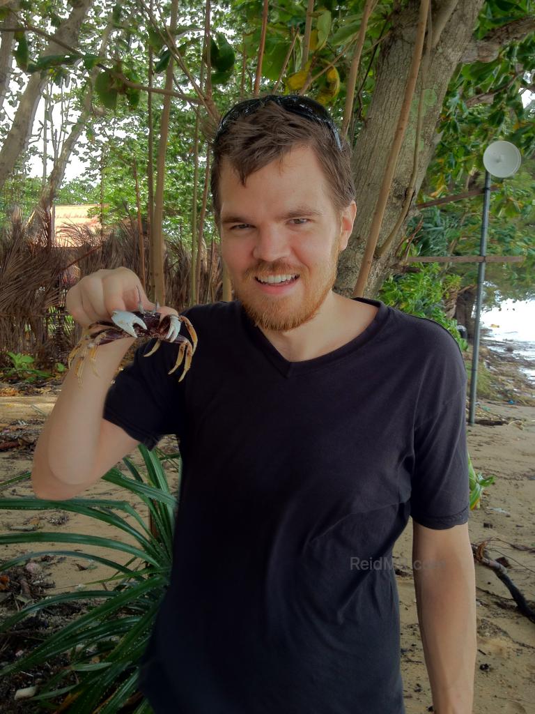 Holding a crab up by my face. I had not shaved so looked very scruffy. 