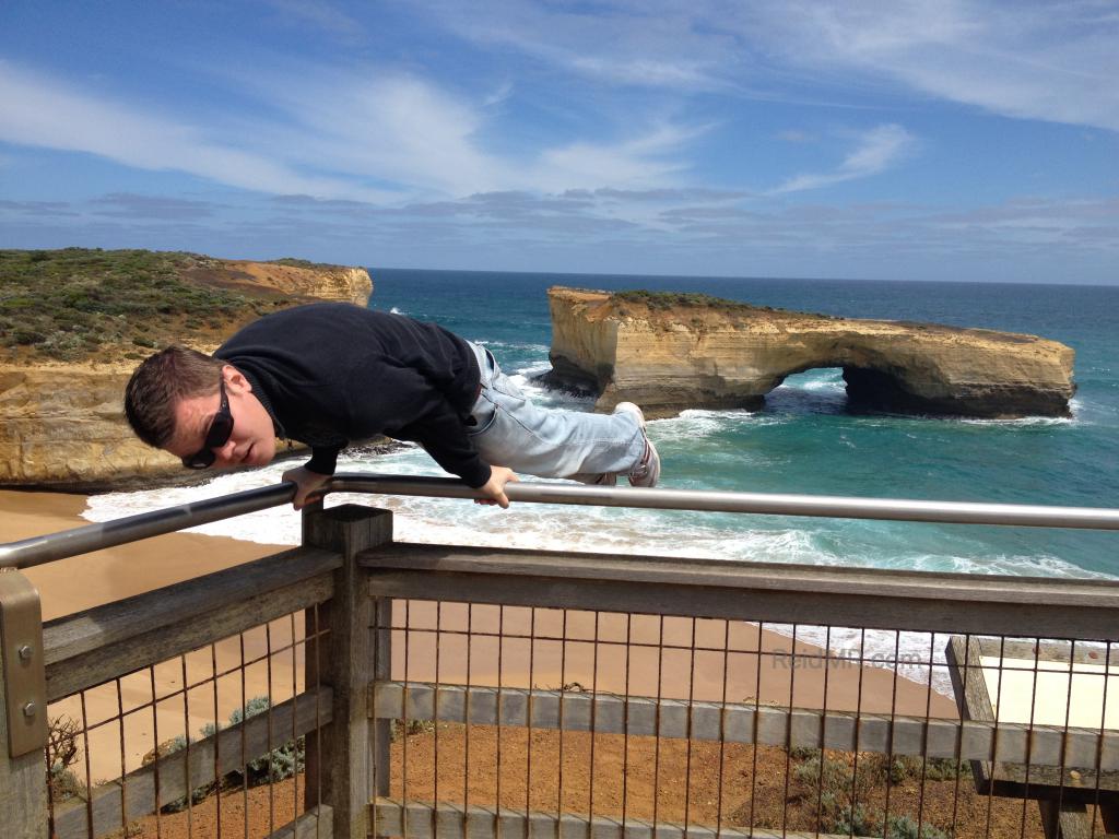 The London Bridge on the Great Ocean Road with me doing an elbow lever on a railing.