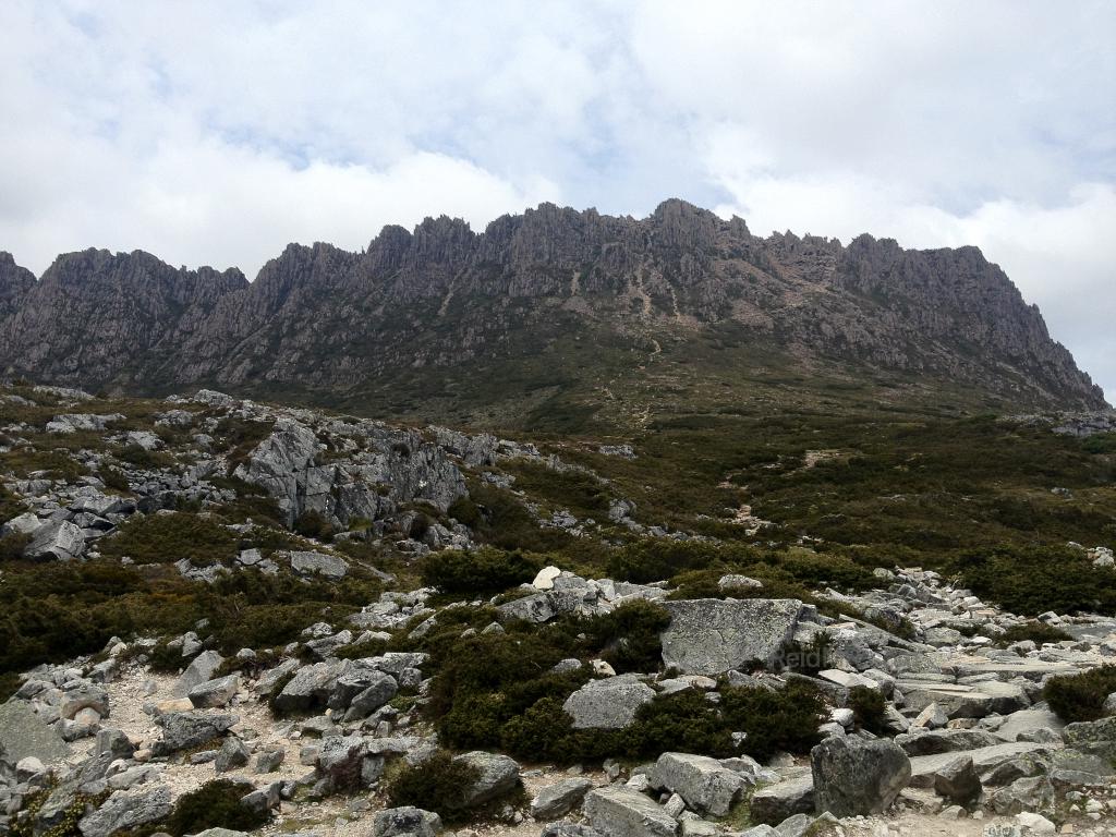 Cradle Mountain with a rocky terrain in the foreground.