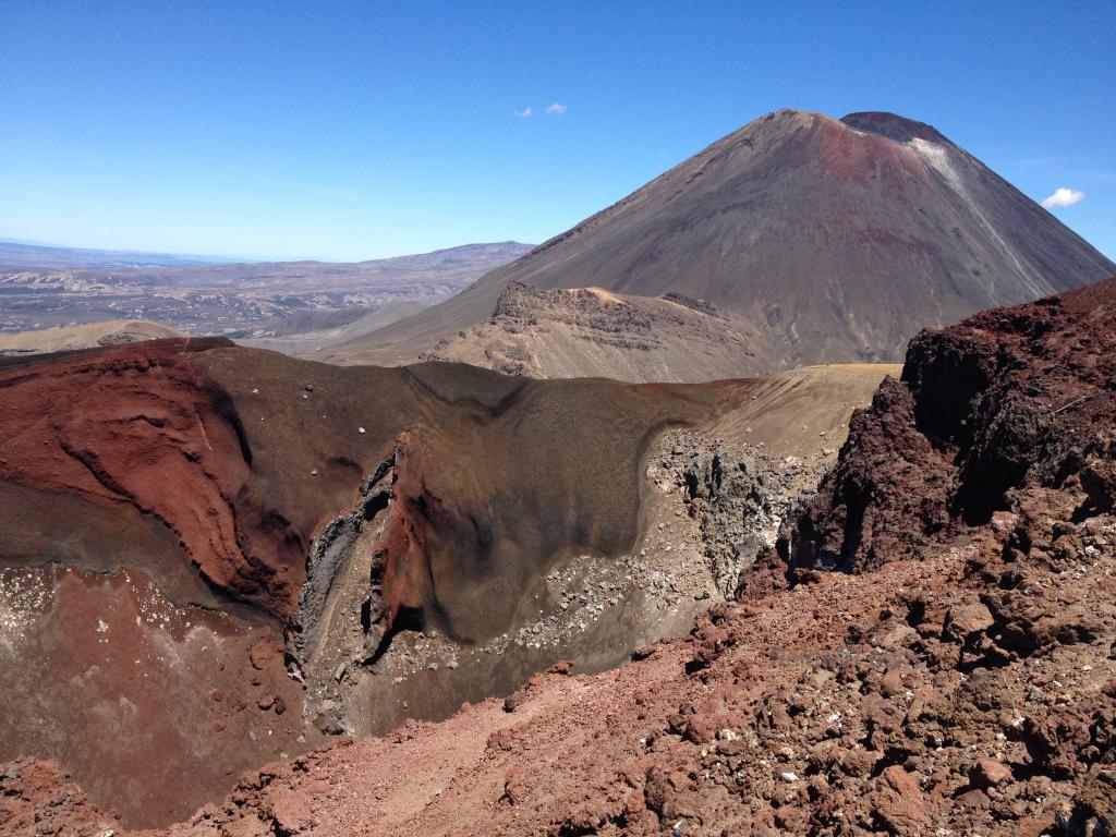 Volcanic mountain with a red rock crater. 