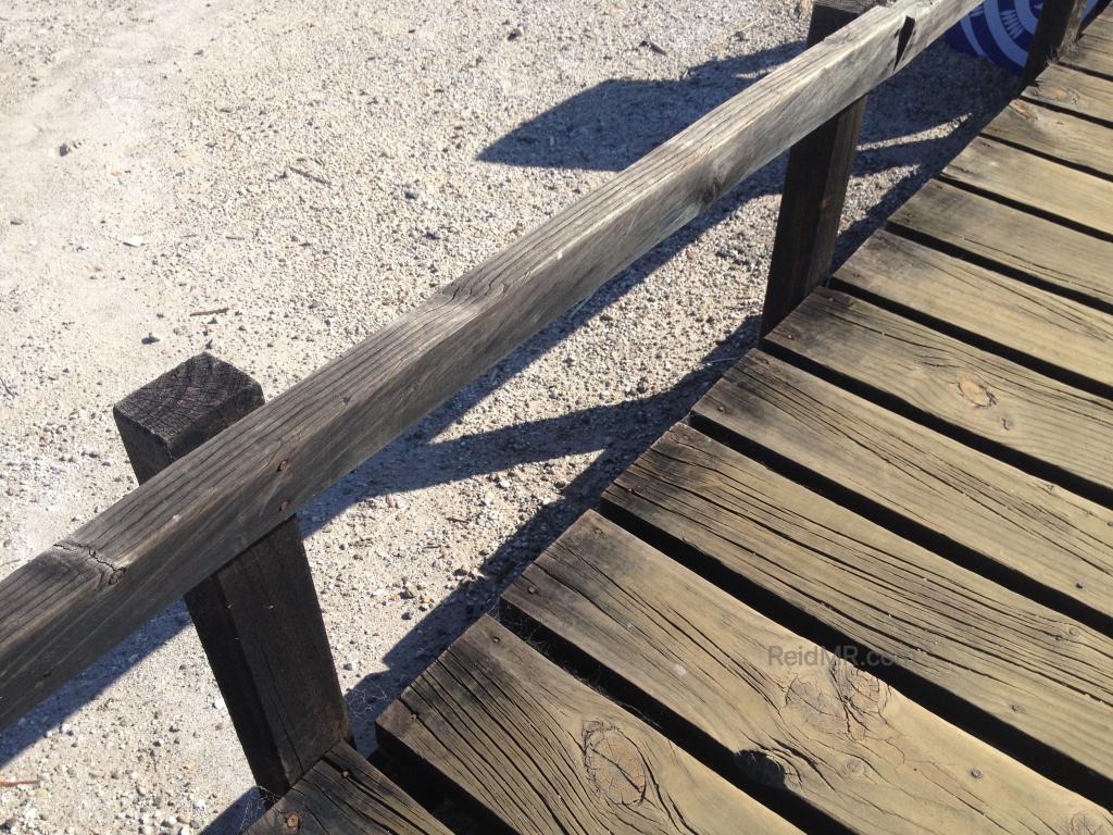 Boardwalk that looks like it had been scorched by fire.